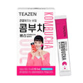 TEAZEN Kombucha Berry — Caja rosa y blanca de kombucha con un retrato impreso, junto a un sobre individual.