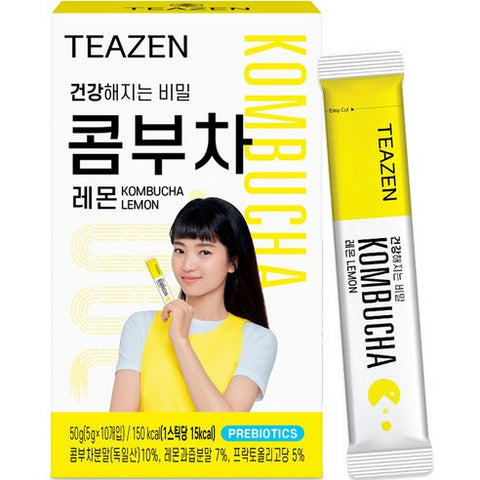 TEAZEN Kombucha Lemon — Yellow-and-white kombucha box with a printed portrait, beside an individual stick.