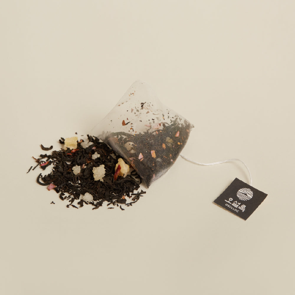 OSULLOC Camellia Forest Tea — Pyramid tea bag beside loose tea blend and OSULLOC tag.