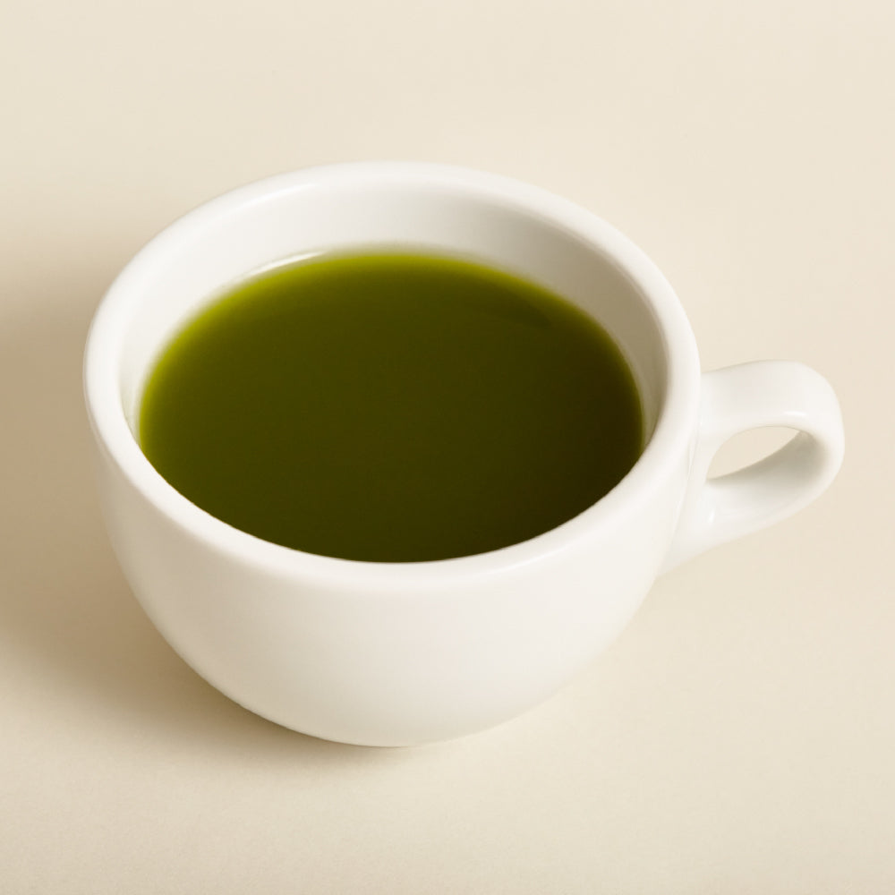 OSULLOC Jeju Green Tea Powder 40 g — Deep green tea in a white ceramic cup.