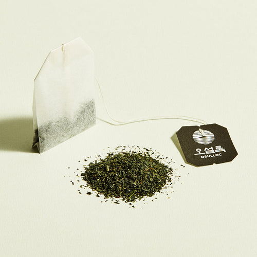 OSULLOC Pure Green Tea — Paper tea bag beside finely cut green tea and a black tag.