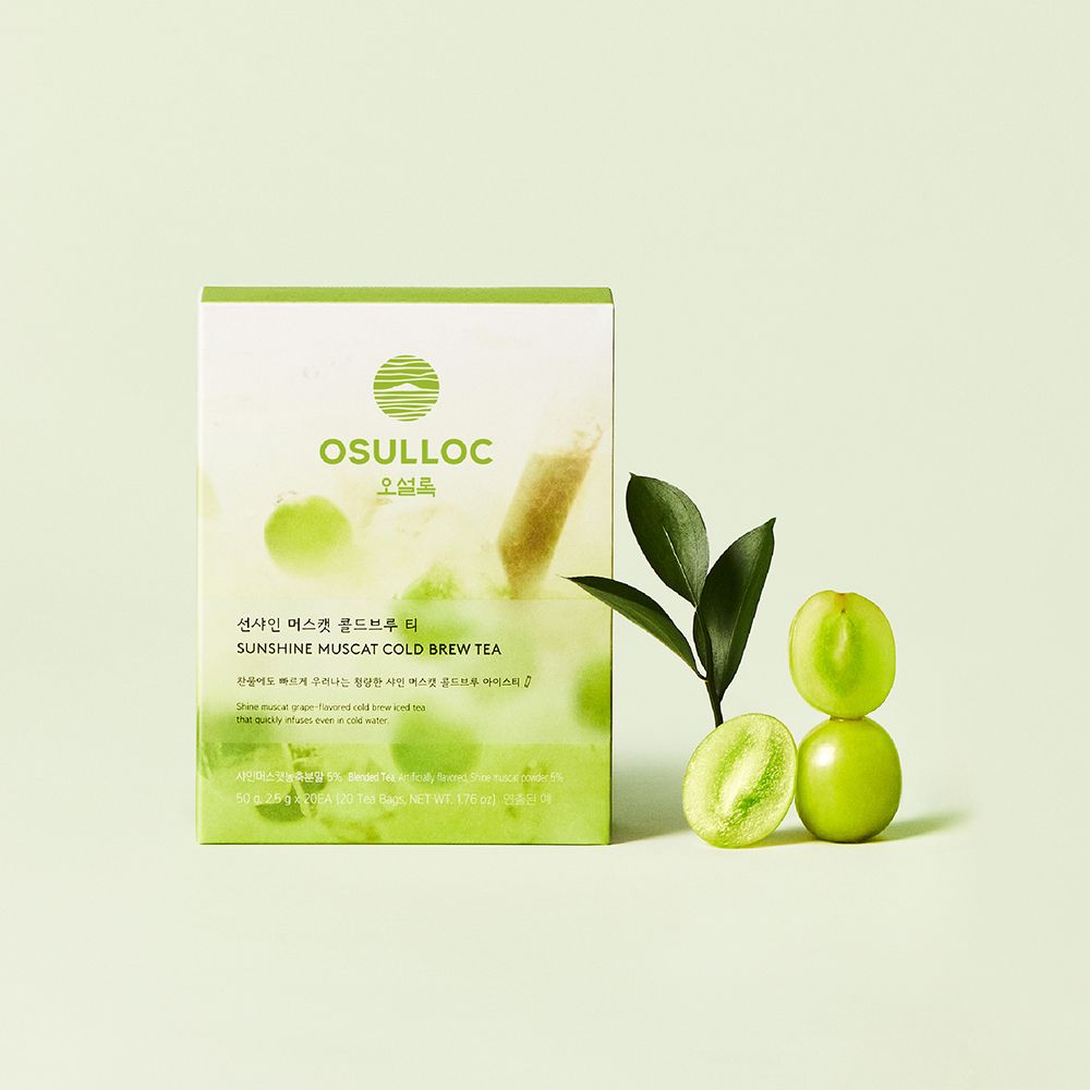OSULLOC Sunshine Muscat Cold Brew Tea — Green-and-white box beside cut green grapes and leaves.