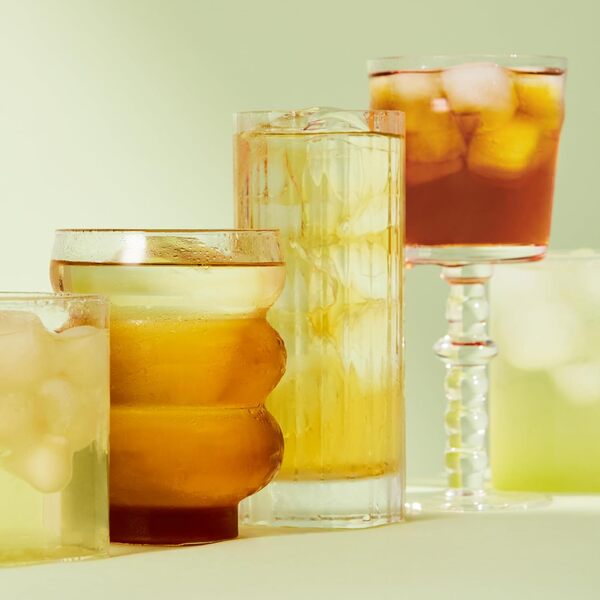 OSULLOC Honey Pear Cold Brew Tea — Assorted glasses of golden and amber iced tea.