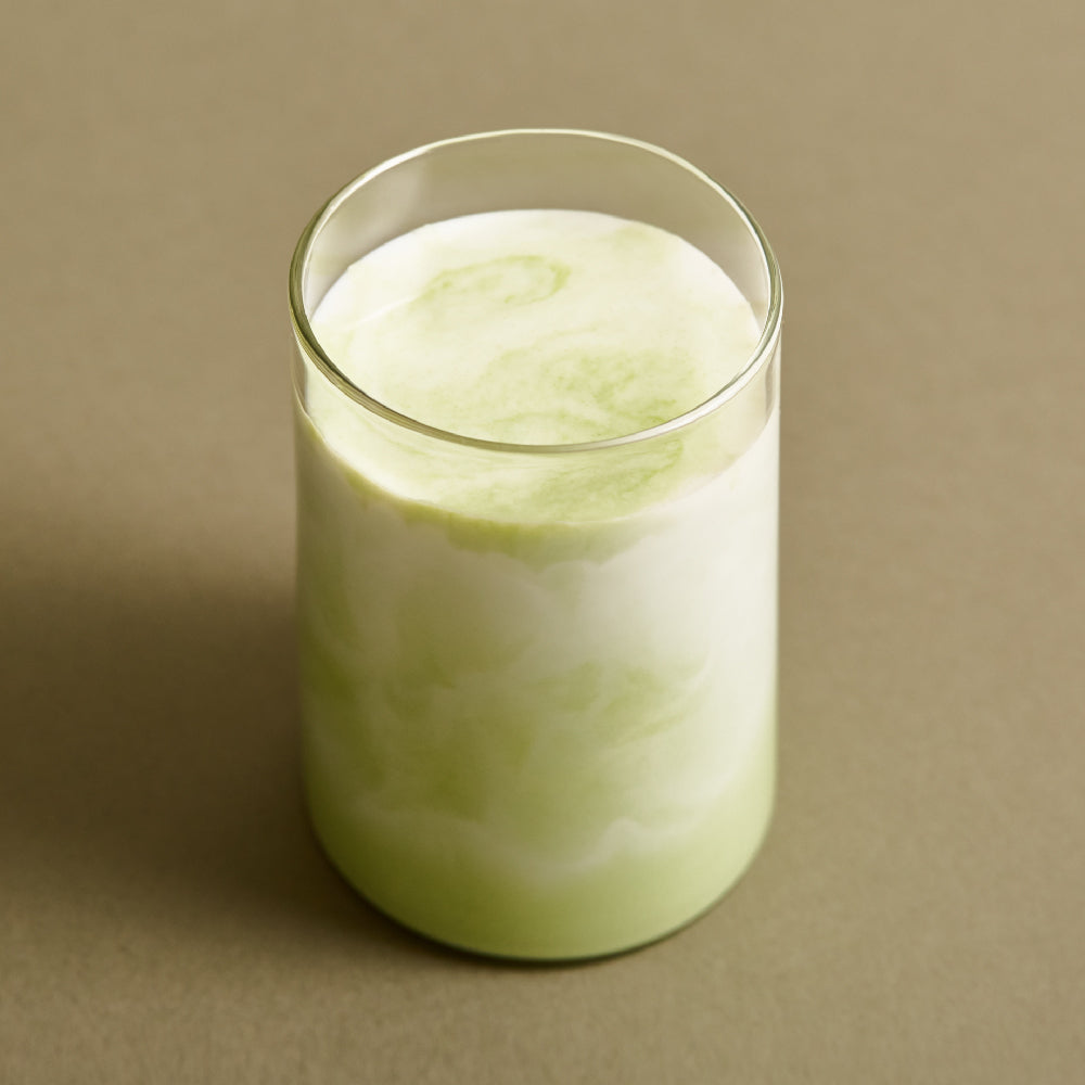 OSULLOC Premium Jeju Matcha Powder 40 g — Green-and-white matcha drink in a clear glass.