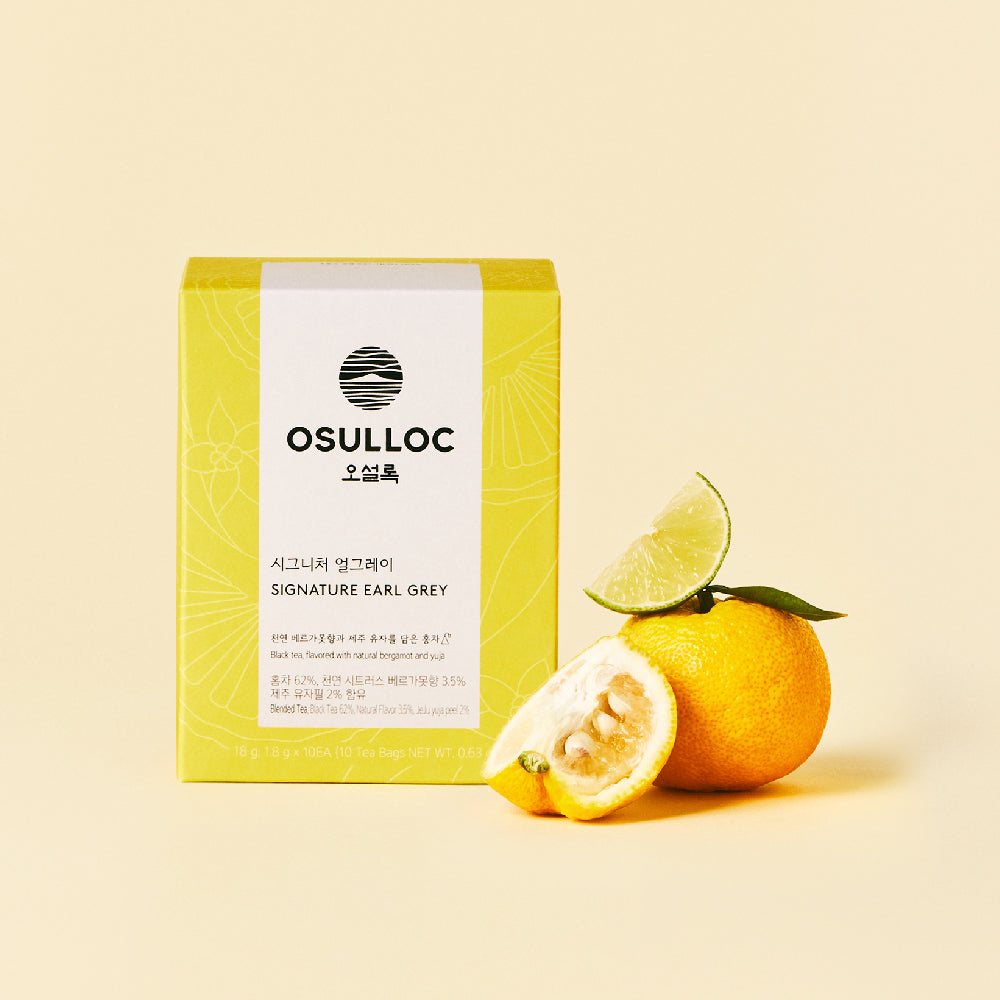OSULLOC Signature Earl Grey — Yellow box beside whole and cut citrus.