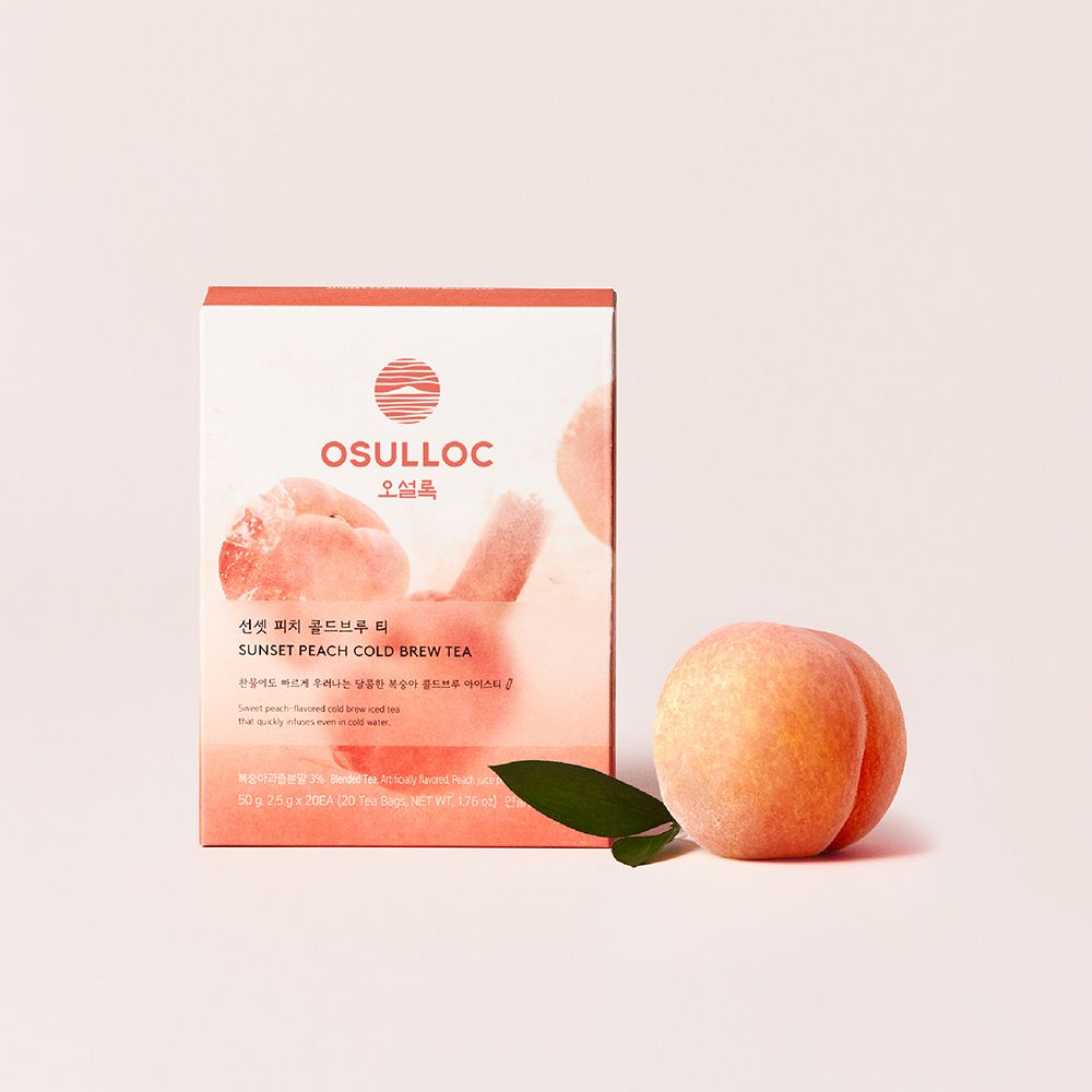 OSULLOC Sunset Peach Cold Brew Tea — Pink-and-white box beside a peach and green leaf.