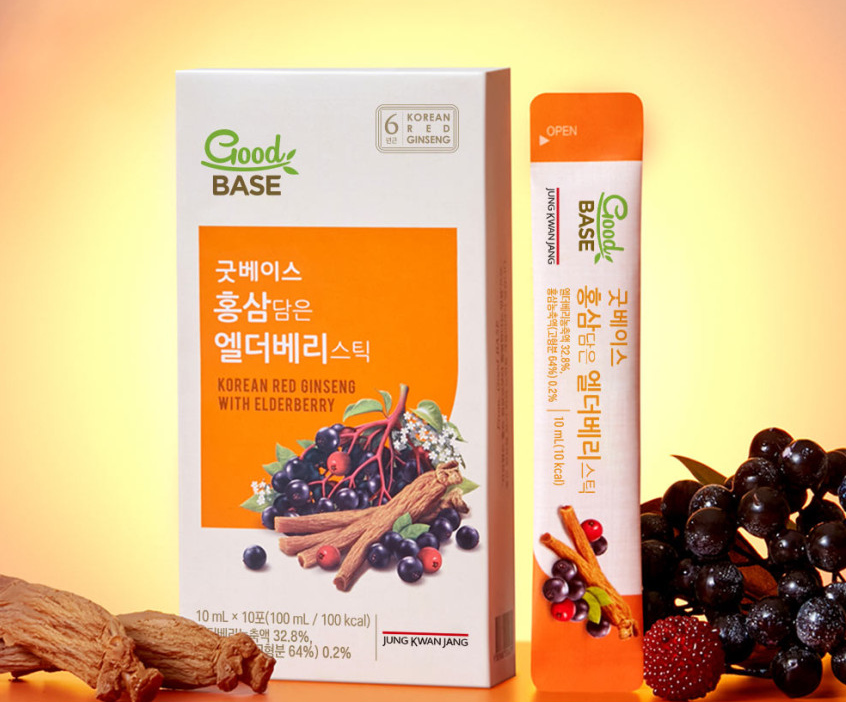 Jung Kwan Jang Good Base Korean Red Ginseng with Elderberry — Orange-and-white carton and stick beside berries and roots.