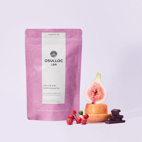 OSULLOC Fig Apple Black Tea — Pink pouch beside cut fig, apple slices, red berries and chocolate pieces.