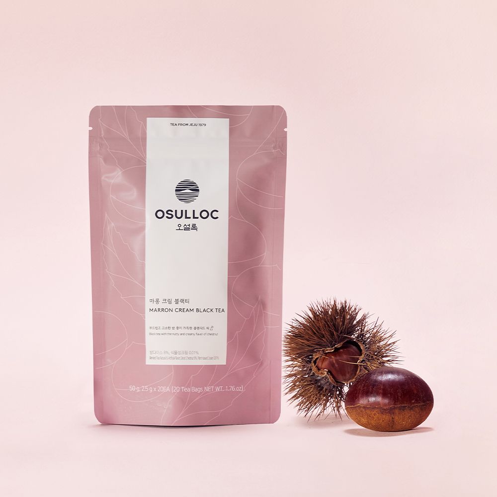 OSULLOC Marron Cream Black Tea — Dusty pink pouch beside a chestnut and its spiny husk.