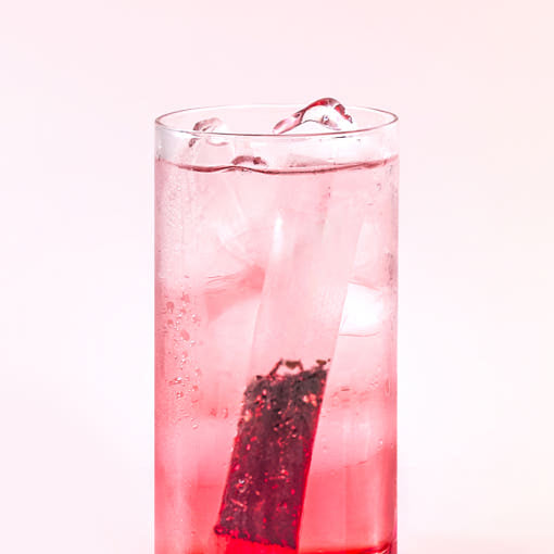 OSULLOC Sweet Hibiscus Cold Brew Tea — Pink iced infusion with a tea bag in a tall clear glass.