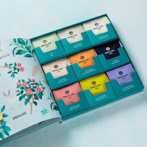 OSULLOC Tea Garden Gift Box — Open illustrated gift box showing nine colourful tea compartments.