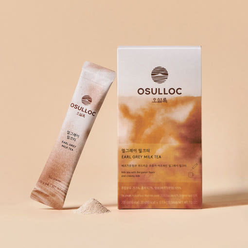 OSULLOC Earl Grey Milk Tea — Earl Grey Milk Tea box and stick beside a small mound of powder.