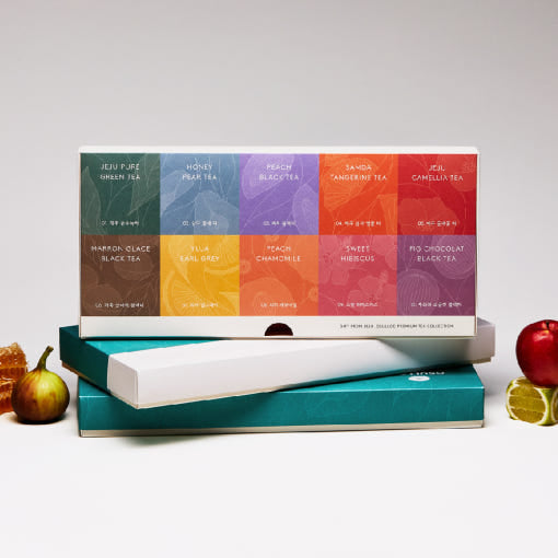 OSULLOC Premium Tea Collection 40 — Open tea collection box with colourful packets beside fruit.