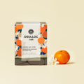 OSULLOC Tangerine Blossom Oolong Tea — Caja con motivos de cítricos junto a una mandarina y flores blancas.