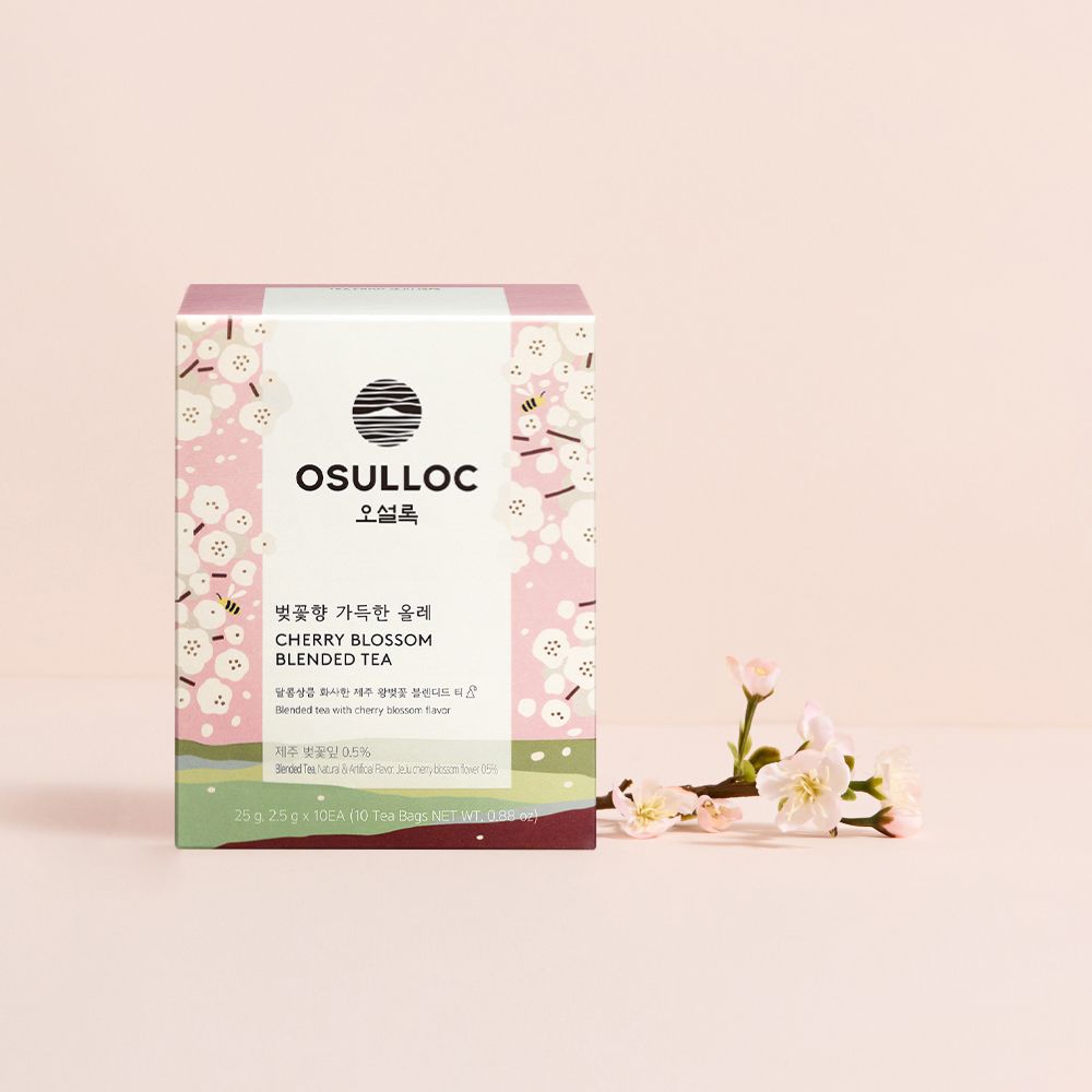 OSULLOC Cherry Blossom Blended Tea — Pink floral box beside a pale flowering branch.