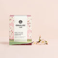 OSULLOC Cherry Blossom Blended Tea — Pink floral box beside a pale flowering branch.