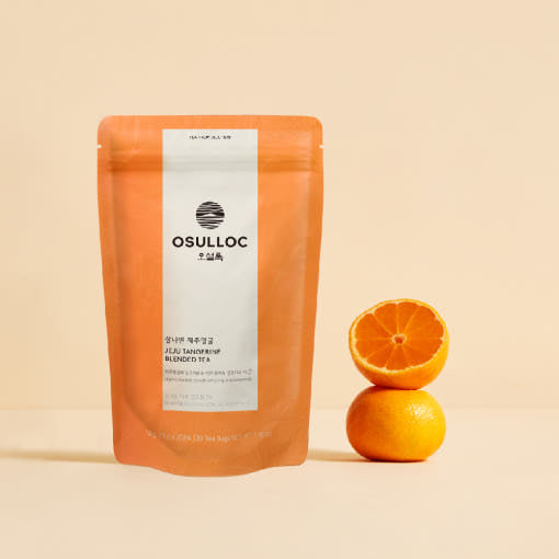 Orange OSULLOC Jeju Tangerine pouch beside a whole citrus fruit and a halved one.