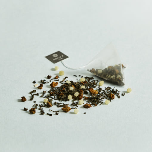 OSULLOC Moon Walk Tea — Pyramid tea bag beside a scattered loose tea blend.