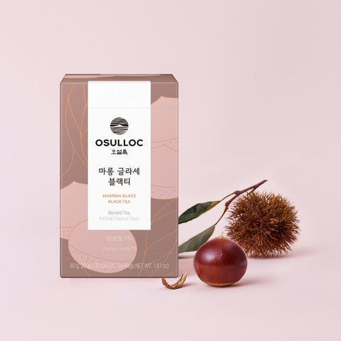 OSULLOC Marron Glace Black Tea — Marron Glace box beside a chestnut, spiny husk and leafy twig.