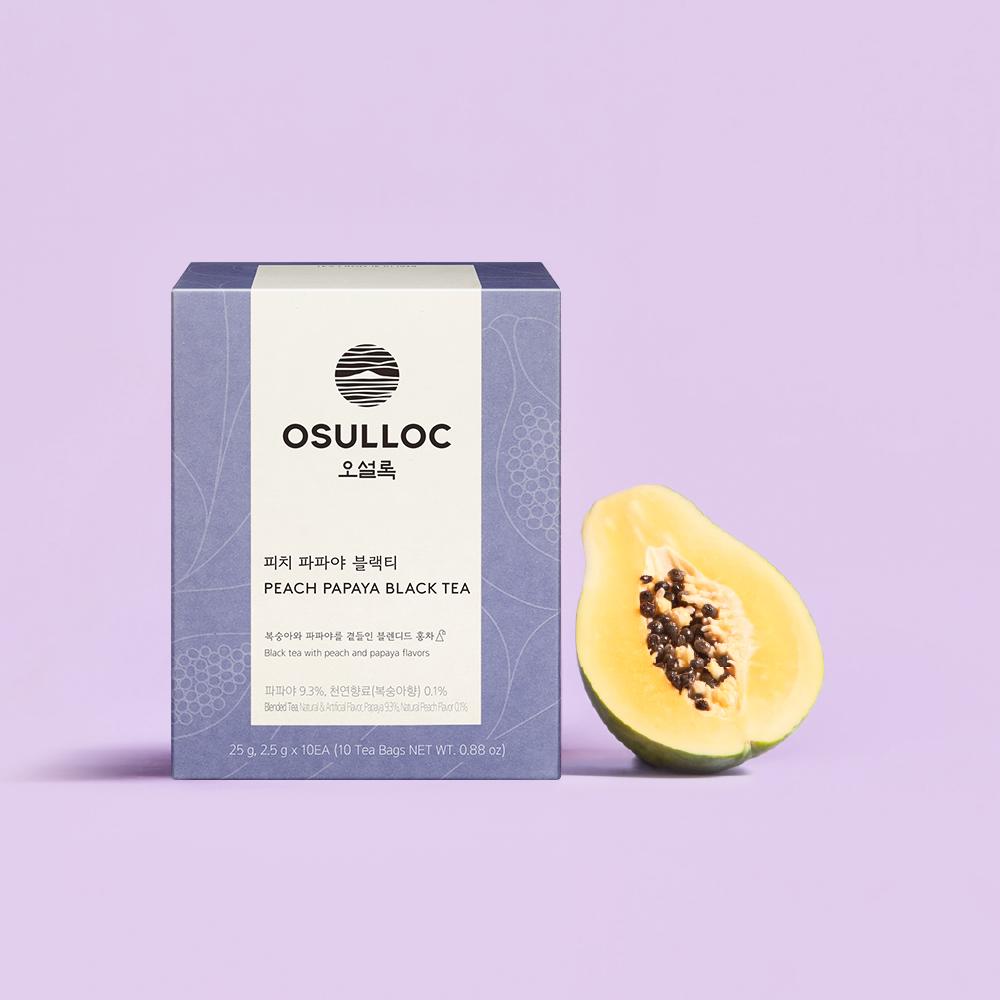 OSULLOC Peach Papaya Black Tea — Purple Peach Papaya box beside half a papaya.