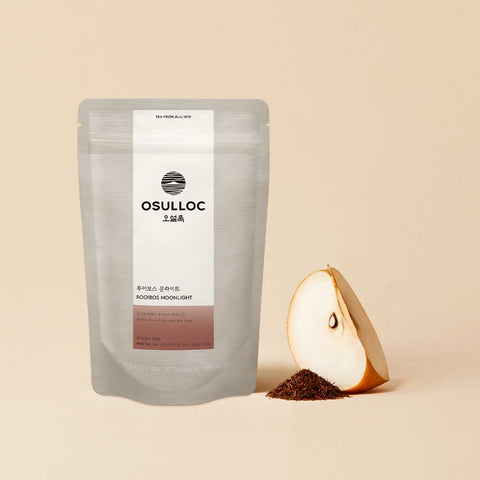 OSULLOC Rooibos Moonlight — Grey Rooibos Moonlight pouch beside a pear wedge and loose rooibos.
