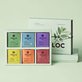 OSULLOC Tea Variation 30 Gift Set — Caja de regalo verde abierta con seis compartimentos de té de colores.