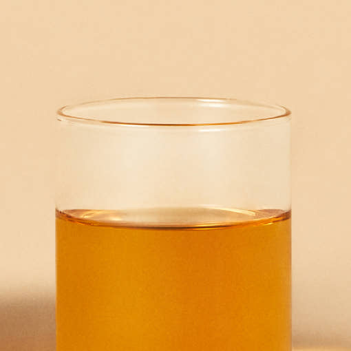 OSULLOC Tangerine Blossom Tea — Amber tea in a clear glass.