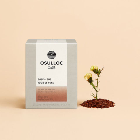 OSULLOC Rooibos Pure — Grey box beside small yellow flowers rising from a mound of loose rooibos.