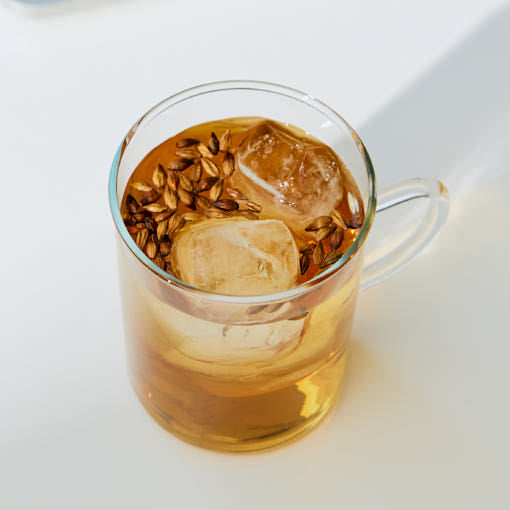 OSULLOC Rooibos Pure — Clear handled cup of amber iced infusion in sunlight.