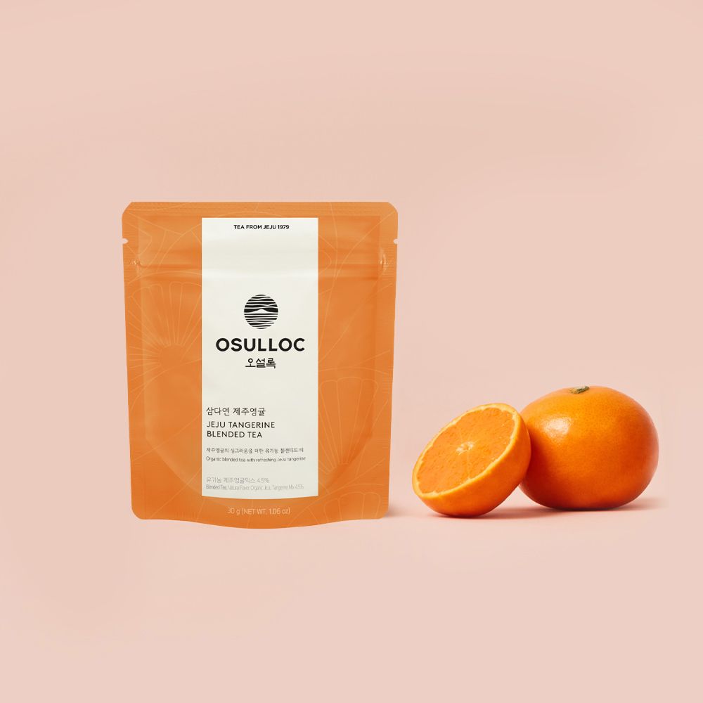 OSULLOC Jeju Tangerine Blended Tea 30 g — Orange pouch beside whole and cut mandarins.