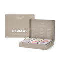 OSULLOC Premium Tea Collection 90 — Open grey gift box holding small illustrated tea cartons, beside a matching closed grey box.